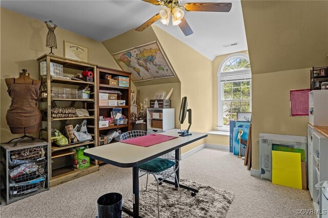 office space featuring visible vents, lofted ceiling, baseboards, a ceiling fan, and carpet
