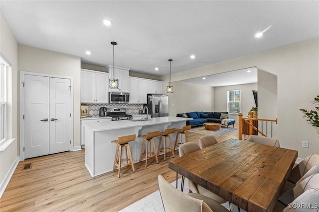 dining room featuring recessed lighting, visible vents, and light wood finished floors