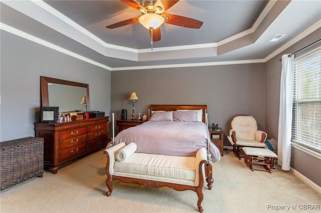 bedroom featuring crown molding, ceiling fan, carpet floors, a tray ceiling, and visible vents