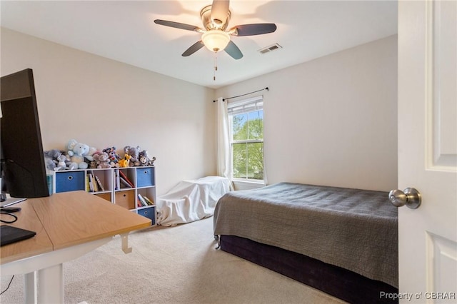 carpeted bedroom featuring visible vents and a ceiling fan