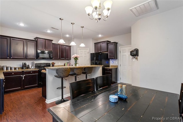 dining area featuring recessed lighting, visible vents, dark wood-style flooring, and an inviting chandelier