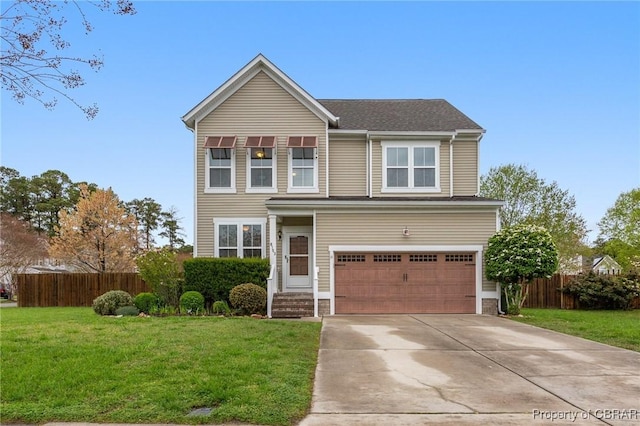 traditional home with fence, driveway, a front yard, and a garage