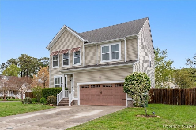 traditional home featuring an attached garage, a front lawn, fence, and concrete driveway