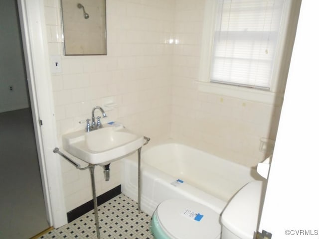 bathroom with tile walls and toilet