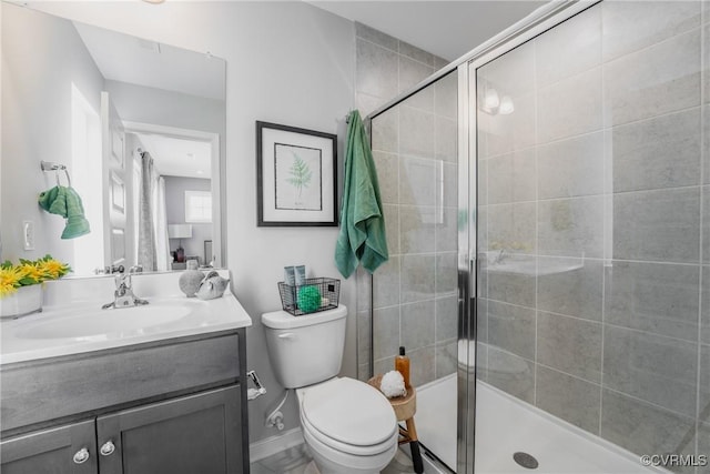 full bath with vanity, toilet, and a shower stall