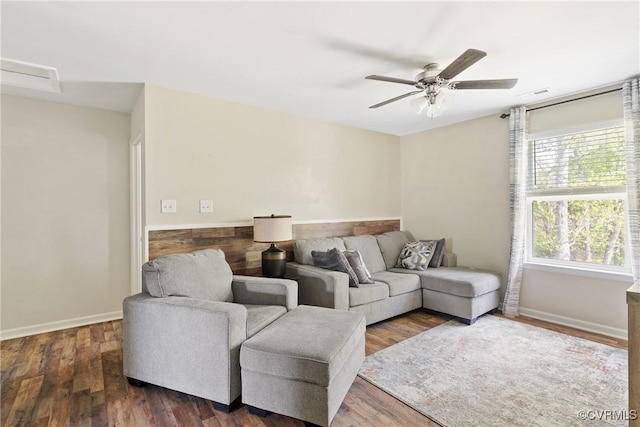 living room with ceiling fan, dark wood-style flooring, and baseboards