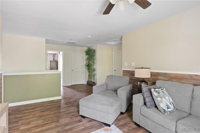 living room featuring wood finished floors, ceiling fan, and baseboards