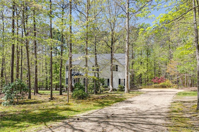 view of front of home featuring a wooded view