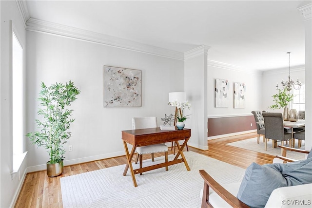 office featuring baseboards, crown molding, and light wood-style flooring