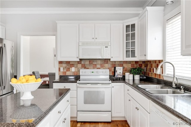 kitchen with white cabinets, white appliances, and a sink