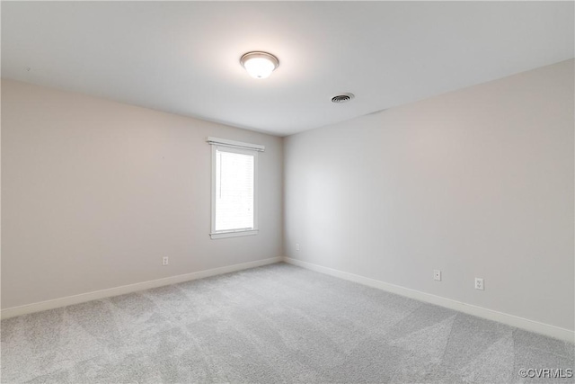 empty room with light carpet, baseboards, and visible vents