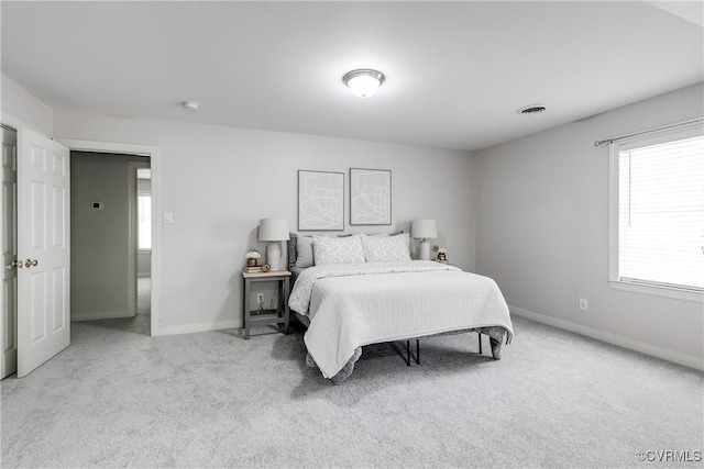 bedroom featuring carpet floors, visible vents, and baseboards