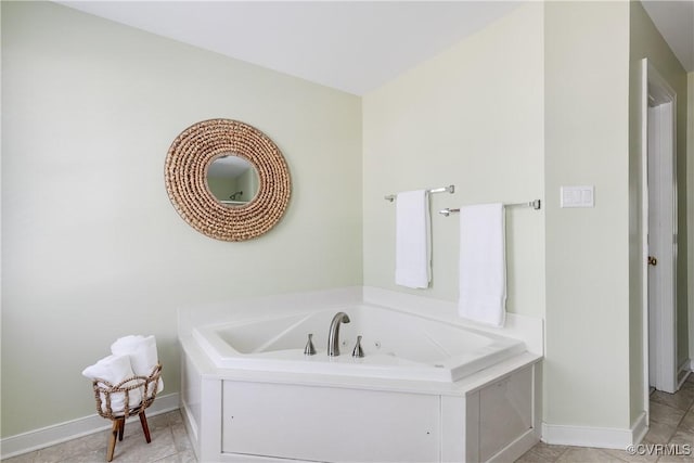 full bath featuring a bath, tile patterned flooring, and baseboards