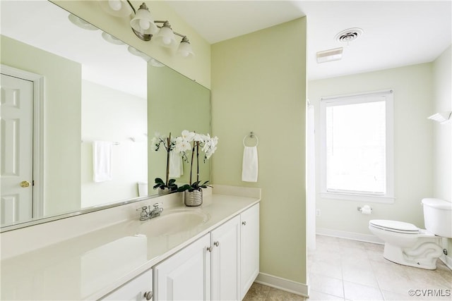 bathroom featuring tile patterned floors, vanity, baseboards, toilet, and visible vents