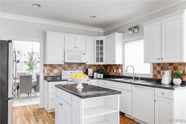 kitchen with open shelves, white cabinetry, a sink, and white appliances