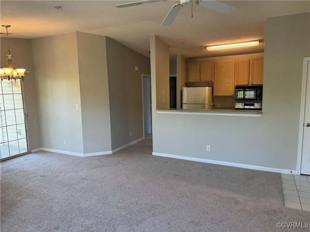 unfurnished living room featuring baseboards, ceiling fan with notable chandelier, a textured ceiling, and carpet