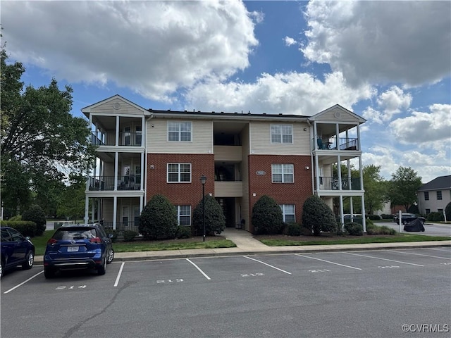 view of building exterior with uncovered parking