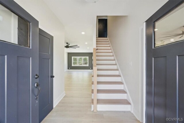 entryway with stairway, a ceiling fan, light wood-style floors, baseboards, and recessed lighting