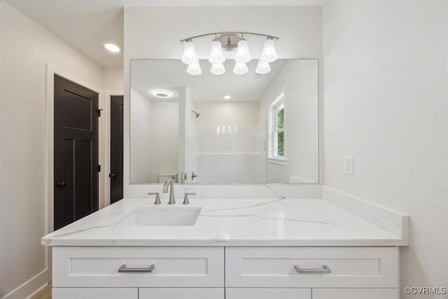 full bathroom featuring a notable chandelier, vanity, a shower, and toilet