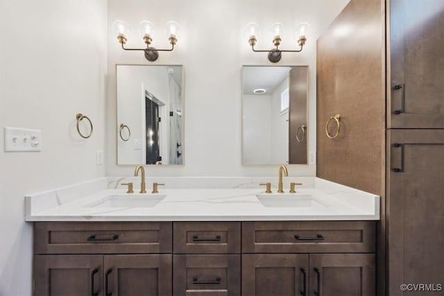 bathroom with a sink and double vanity