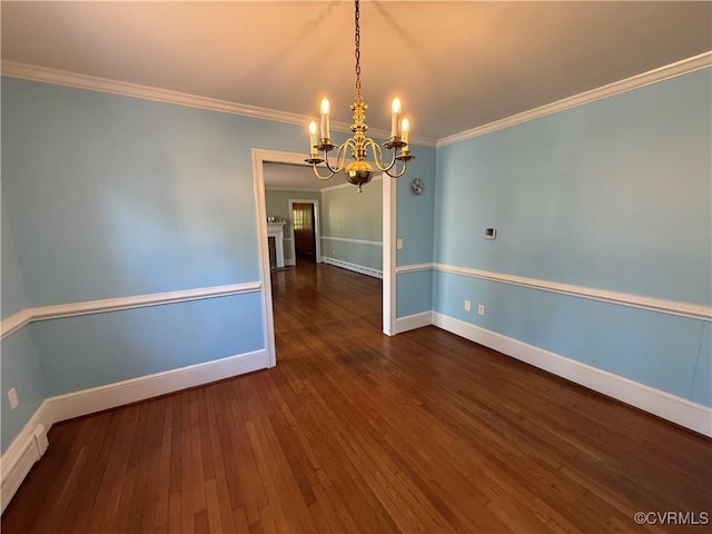 unfurnished room with an inviting chandelier, wood-type flooring, a baseboard heating unit, crown molding, and baseboards