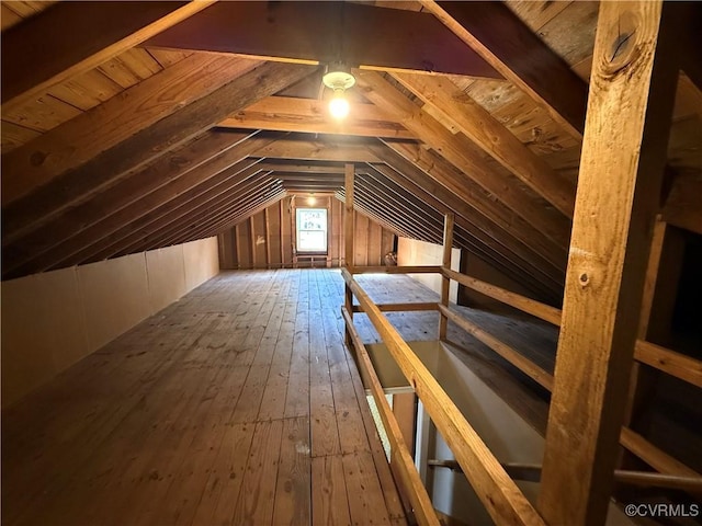 unfinished attic with an upstairs landing