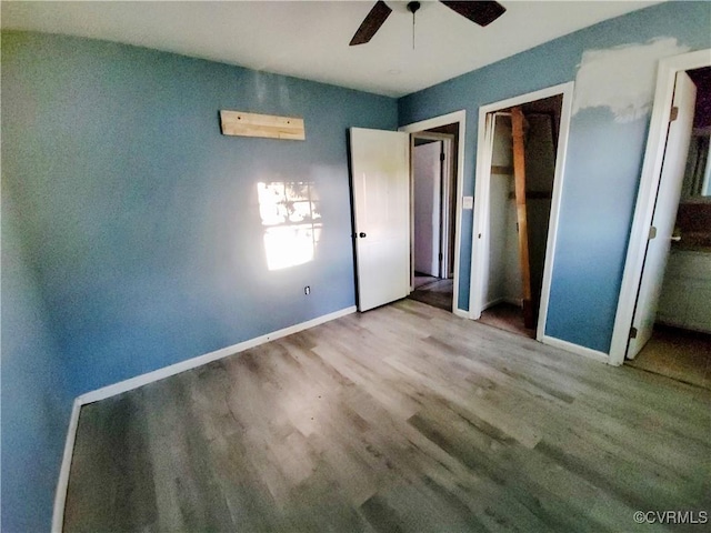 unfurnished bedroom featuring baseboards, a ceiling fan, and wood finished floors