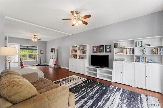 living area with baseboards, a ceiling fan, and wood finished floors