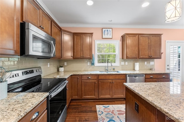 kitchen featuring a sink, dark wood-style flooring, brown cabinets, light stone counters, and appliances with stainless steel finishes
