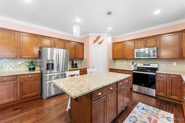 kitchen with backsplash, appliances with stainless steel finishes, crown molding, and a kitchen island