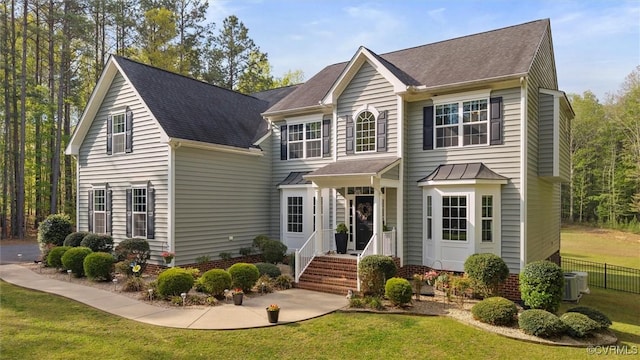 traditional-style house featuring fence and a front yard