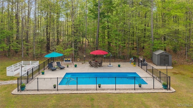 view of swimming pool featuring a yard, a patio area, a fenced in pool, and fence
