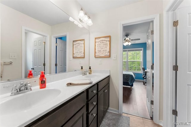 full bathroom featuring double vanity, ensuite bath, tile patterned floors, and a sink