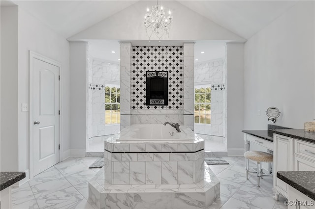 2403 Bermuda Ave, Chester, VA 23836 - bathroom featuring marble finish floor, an inviting chandelier, vaulted ceiling, baseboards, and a garden tub