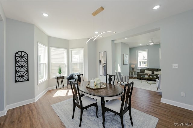 dining space with recessed lighting, wood finished floors, and baseboards