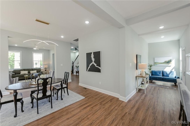 dining space featuring visible vents, baseboards, recessed lighting, wood finished floors, and stairway