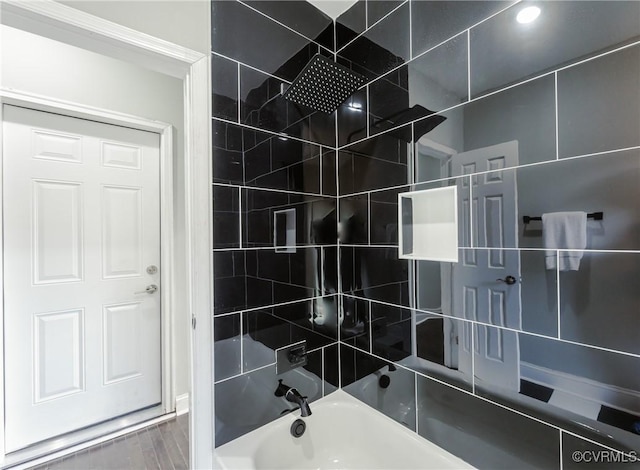 bathroom with shower / bathtub combination and wood finished floors