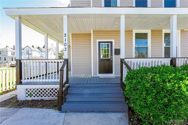 doorway to property featuring covered porch