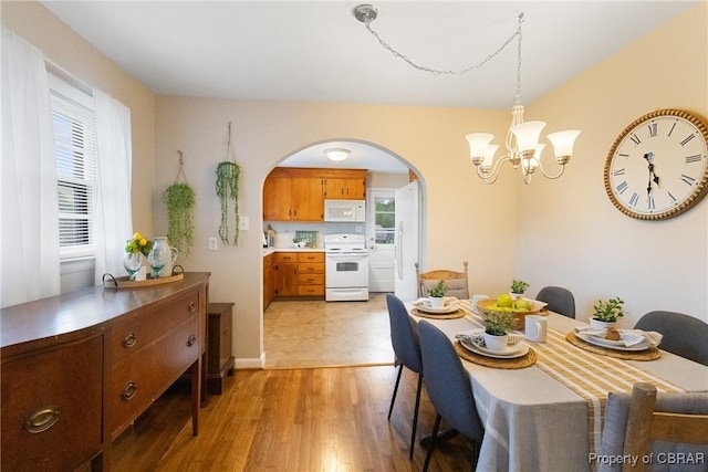 16 Lakeview Dr, Newport News, VA 23602 - dining space with light wood-type flooring, arched walkways, a chandelier, and a wealth of natural light
