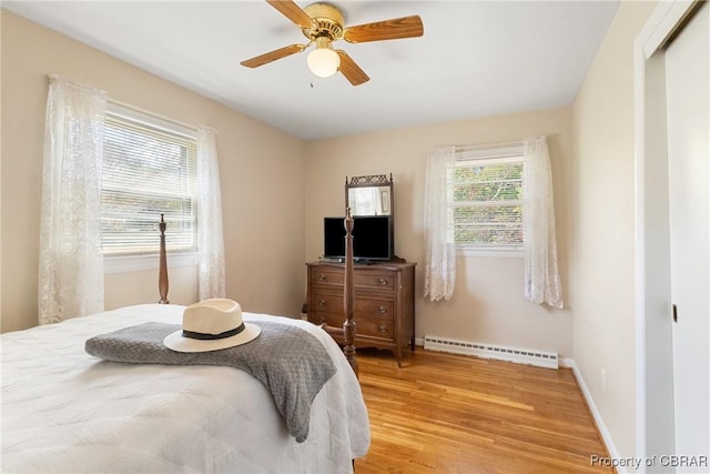 16 Lakeview Dr, Newport News, VA 23602 - bedroom featuring a baseboard heating unit, light wood finished floors, and a ceiling fan
