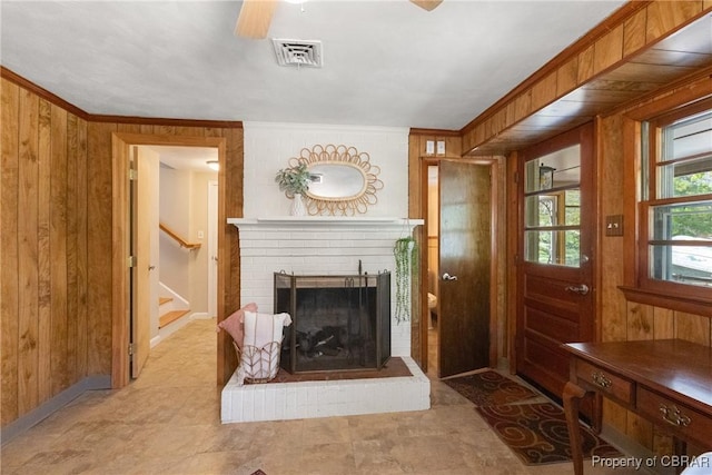 16 Lakeview Dr, Newport News, VA 23602 - living area with a fireplace, wood walls, a ceiling fan, visible vents, and stairway