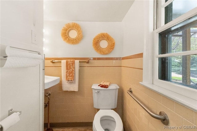16 Lakeview Dr, Newport News, VA 23602 - half bath featuring toilet, tile walls, a wealth of natural light, and a wainscoted wall