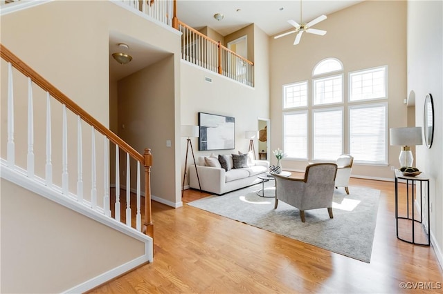 10317 White Marsh Rd, Henrico, VA 23060 - living room with ceiling fan, a high ceiling, wood finished floors, and stairs