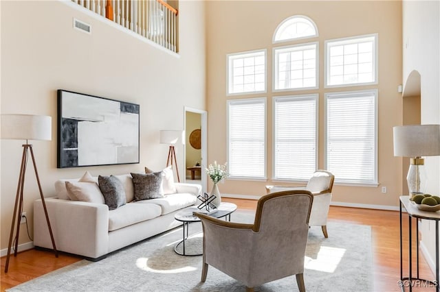 10317 White Marsh Rd, Henrico, VA 23060 - living room featuring wood finished floors, a high ceiling, and arched walkways