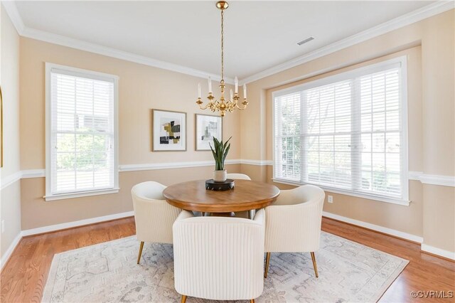 10317 White Marsh Rd, Henrico, VA 23060 - dining space with a chandelier, wood finished floors, and crown molding