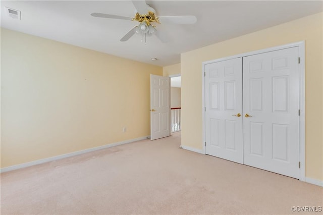 unfurnished bedroom with baseboards, visible vents, a ceiling fan, a closet, and carpet floors