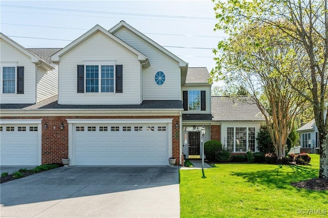 multi unit property with driveway, brick siding, a front yard, and a garage