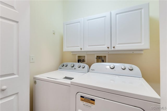 laundry area featuring separate washer and dryer and cabinet space
