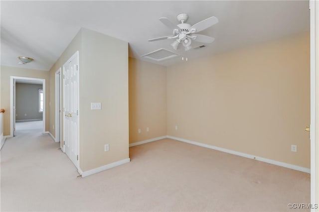 spare room featuring baseboards, visible vents, light colored carpet, and ceiling fan