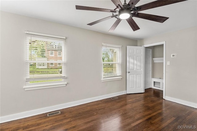 unfurnished bedroom with baseboards, wood finished floors, visible vents, and a ceiling fan